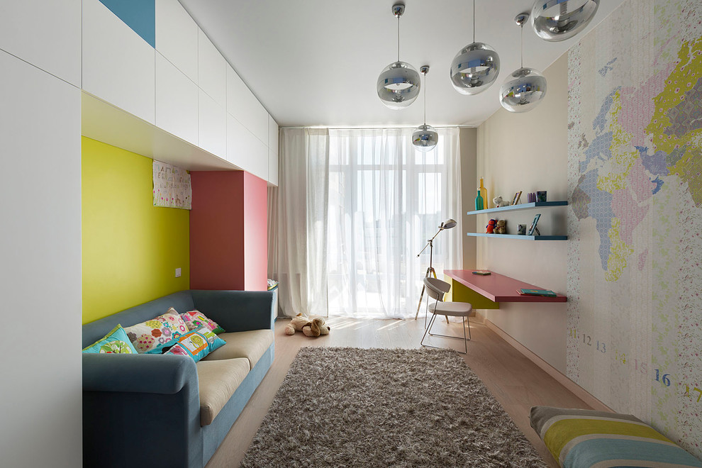 Design ideas for a contemporary gender-neutral kids' study room for kids 4-10 years old in Other with beige walls and light hardwood floors.