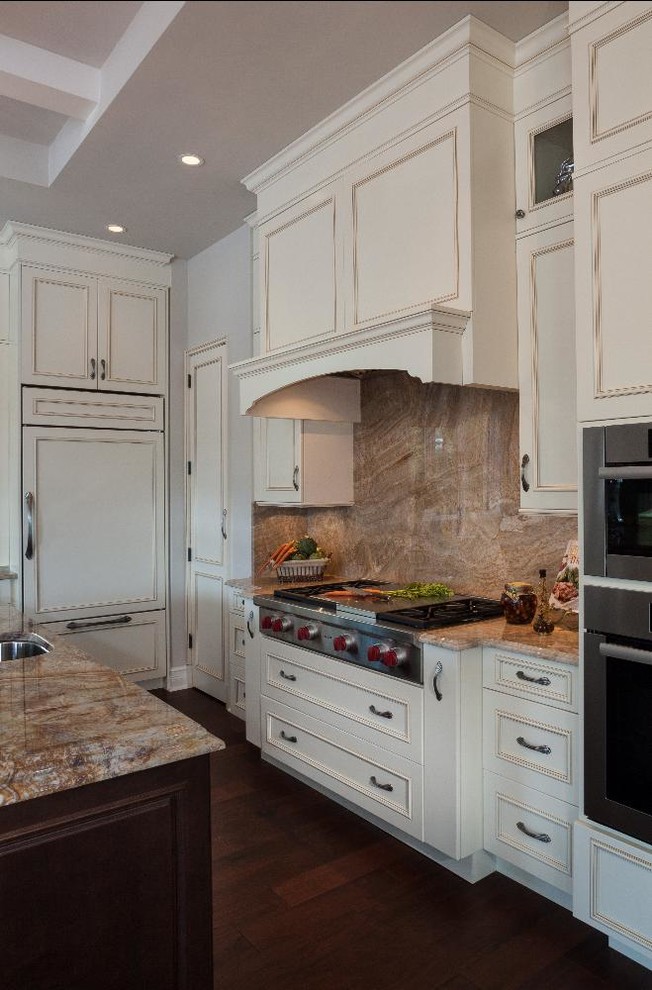 Eat-in kitchen - mid-sized traditional laminate floor eat-in kitchen idea with flat-panel cabinets, two islands, white cabinets, granite countertops, brown backsplash and white walls