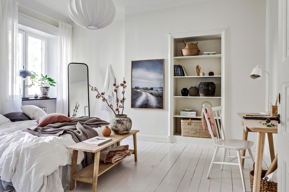 This is an example of a large scandinavian master bedroom in Gothenburg with white walls, painted wood floors and white floor.