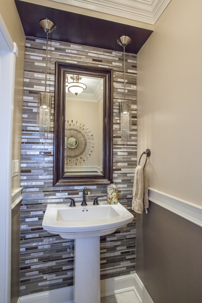 This is an example of a small contemporary powder room in Toronto with multi-coloured tile, multi-coloured walls, porcelain floors, a pedestal sink and matchstick tile.