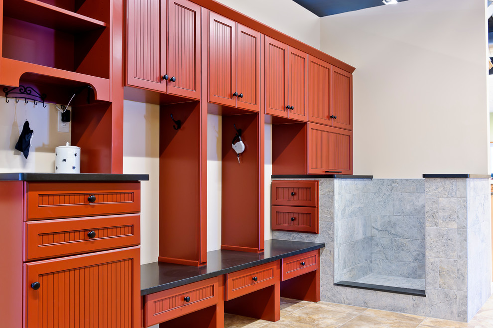 Inspiration for a large traditional mudroom in Burlington with white walls and travertine floors.
