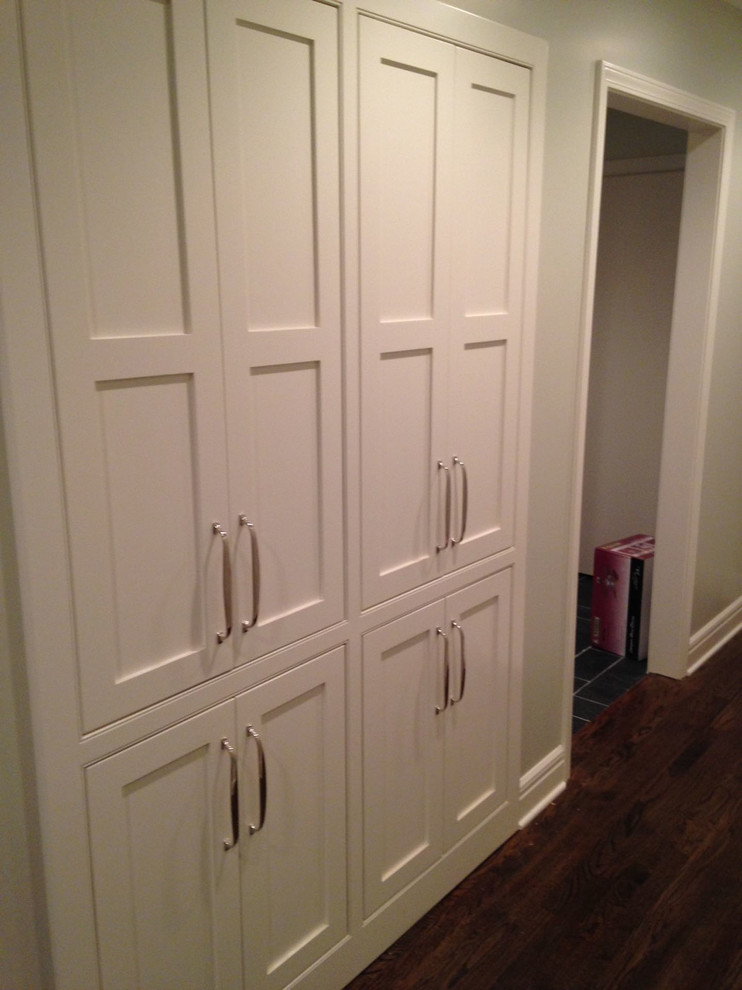 This is an example of a mid-sized contemporary galley laundry cupboard in Kansas City with recessed-panel cabinets, white cabinets, grey walls and dark hardwood floors.