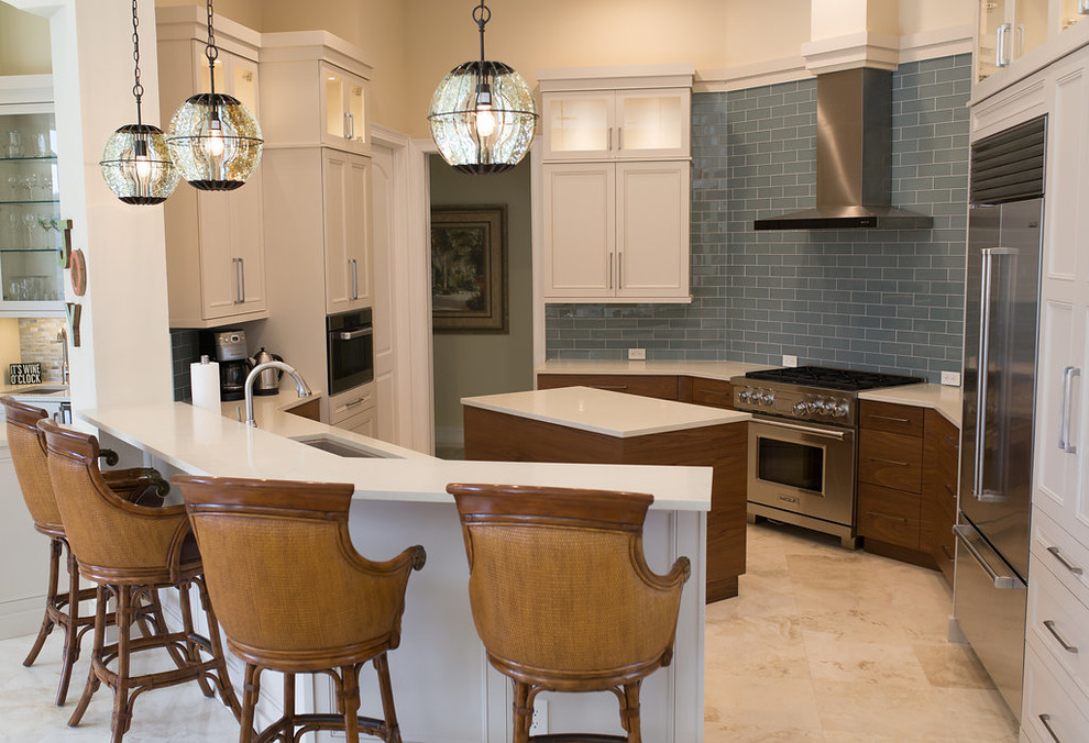 Example of a large transitional u-shaped porcelain tile and beige floor enclosed kitchen design in Miami with an undermount sink, beaded inset cabinets, white cabinets, quartzite countertops, blue backsplash, subway tile backsplash, stainless steel appliances and an island