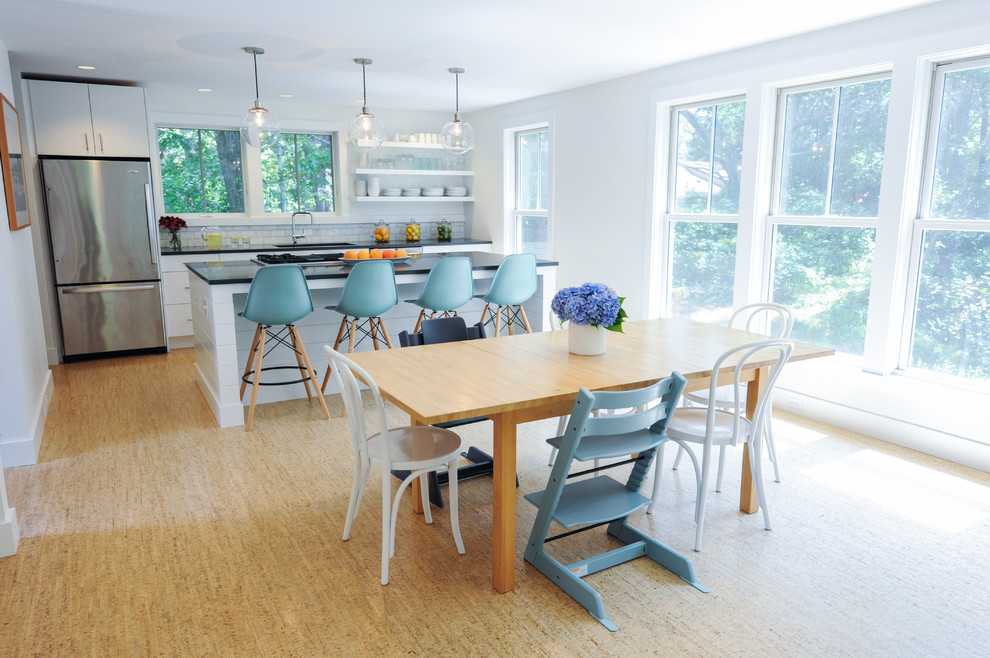 Inspiration for a mid-sized beach style open plan dining in Boston with white walls, bamboo floors and no fireplace.