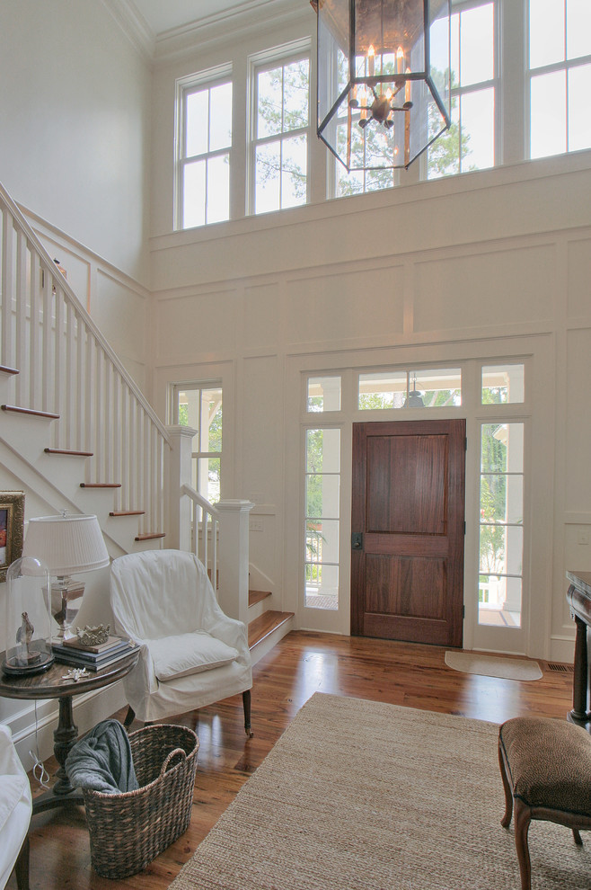 Traditional entryway in Atlanta with white walls, medium hardwood floors, a single front door and a dark wood front door.