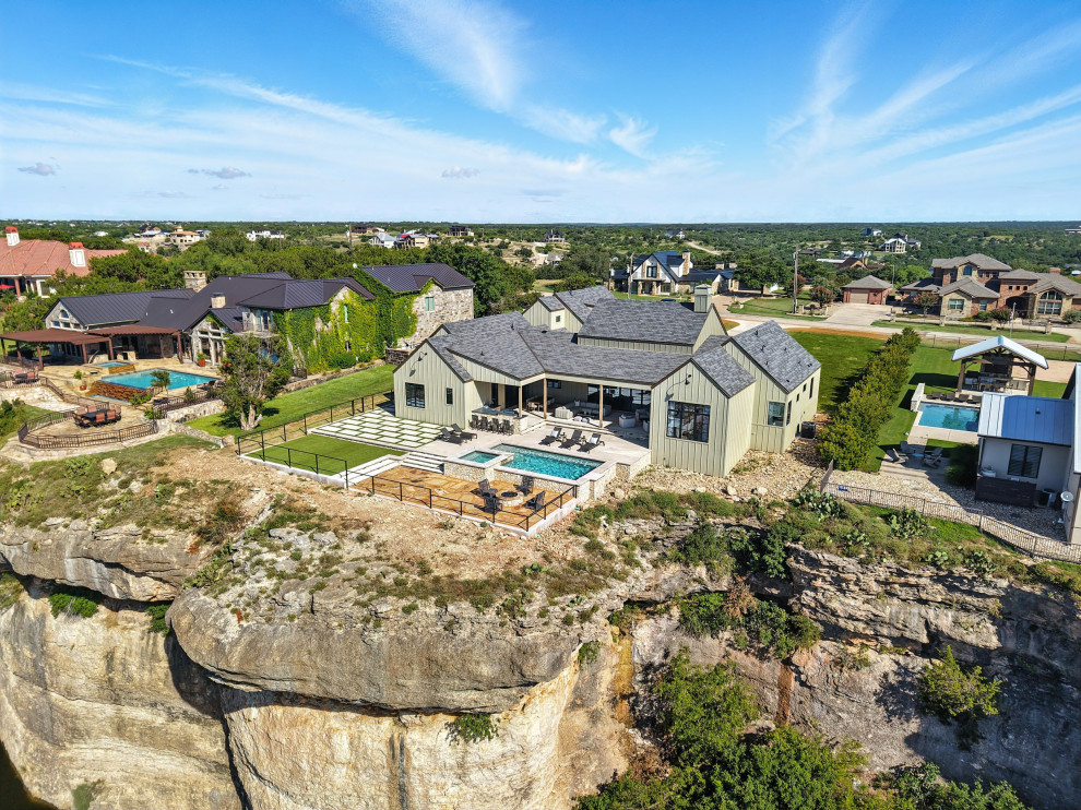 Pool - large modern backyard rectangular pool idea in Dallas