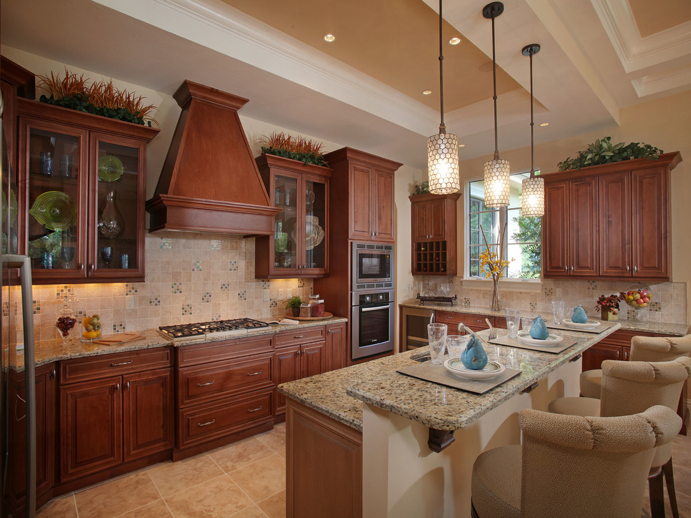 Eat-in kitchen - large transitional l-shaped travertine floor and beige floor eat-in kitchen idea in Miami with an undermount sink, raised-panel cabinets, dark wood cabinets, granite countertops, beige backsplash, ceramic backsplash, stainless steel appliances, an island and multicolored countertops