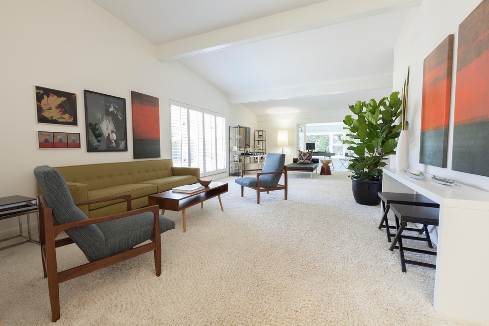 This is an example of a mid-sized midcentury open concept living room in Wilmington with white walls, carpet, a corner fireplace and a brick fireplace surround.