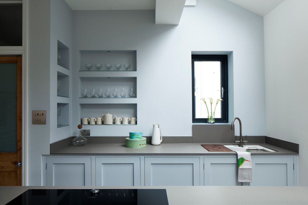 Inspiration for a contemporary galley kitchen in London with an undermount sink, shaker cabinets and blue cabinets.