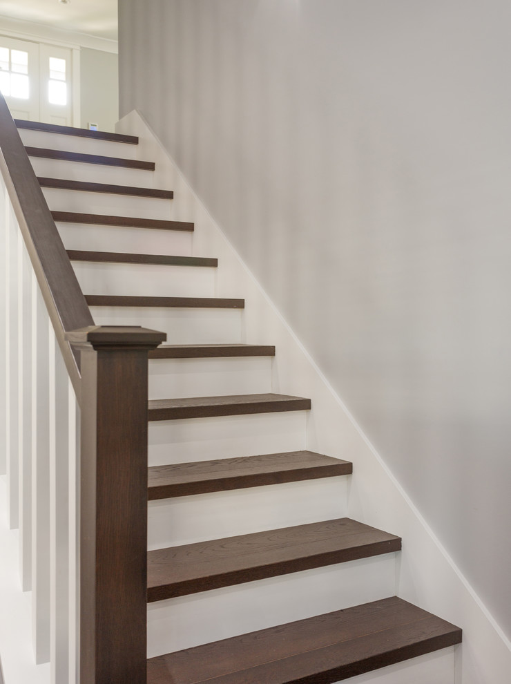 Design ideas for a mid-sized arts and crafts wood l-shaped staircase in Vancouver with painted wood risers and wood railing.