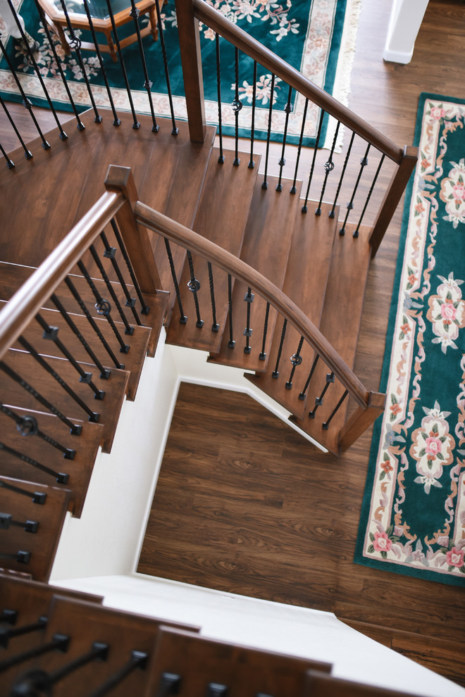 Mid-sized transitional wood u-shaped staircase in San Diego with wood risers and metal railing.