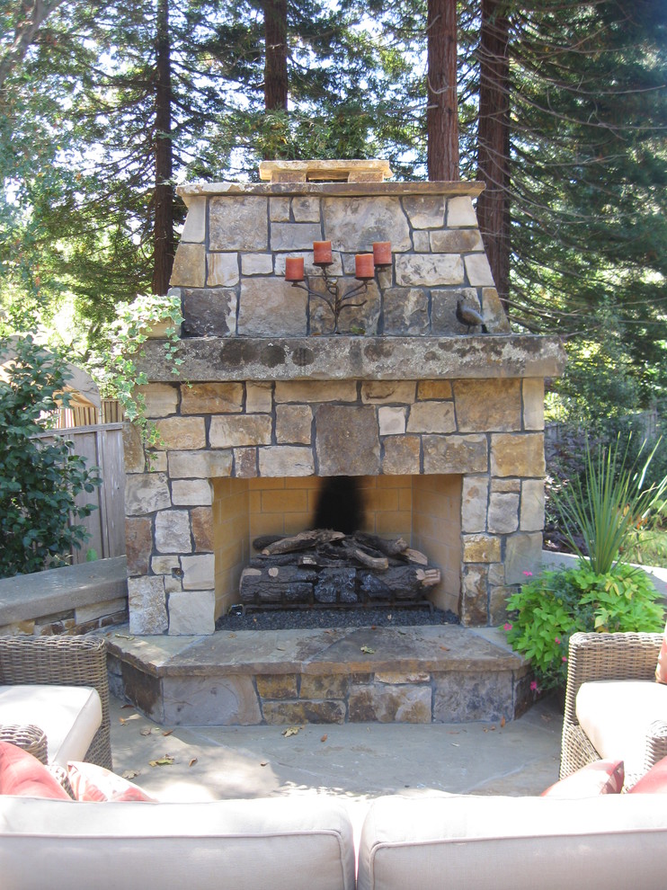 Design ideas for a large traditional backyard patio in San Francisco with a fire feature, natural stone pavers and no cover.