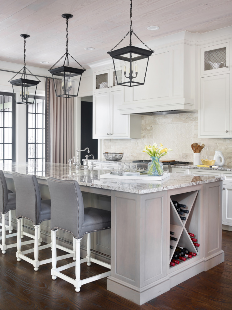 Inspiration for a traditional galley kitchen in Atlanta with a farmhouse sink, recessed-panel cabinets, white cabinets, beige splashback, stainless steel appliances, dark hardwood floors, with island, brown floor, grey benchtop and wood.