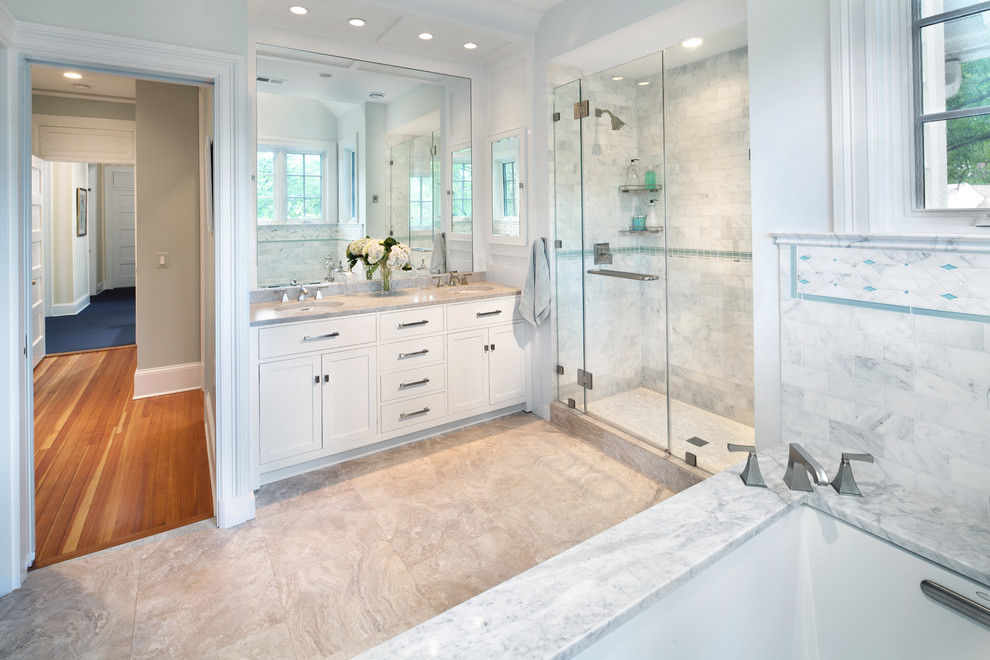Design ideas for a transitional bathroom in DC Metro with marble benchtops and marble.