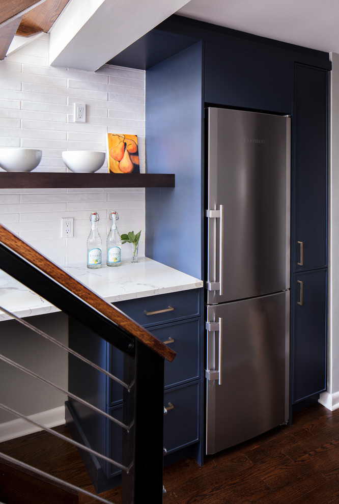 Small transitional dark wood floor and brown floor kitchen photo in New York with a farmhouse sink, blue cabinets, white backsplash, ceramic backsplash, colored appliances and no island