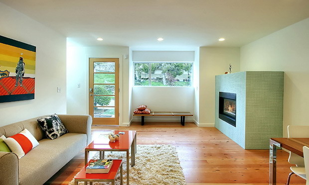 Photo of a mid-sized modern enclosed living room in Wilmington with white walls, medium hardwood floors, a standard fireplace, a tile fireplace surround and brown floor.