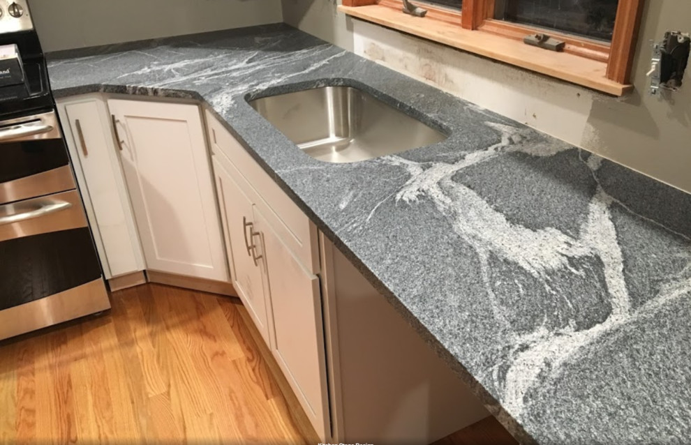 Inspiration for a large l-shaped medium tone wood floor and brown floor open concept kitchen remodel with an undermount sink, recessed-panel cabinets, white cabinets, granite countertops, white backsplash, subway tile backsplash, stainless steel appliances, a peninsula and gray countertops