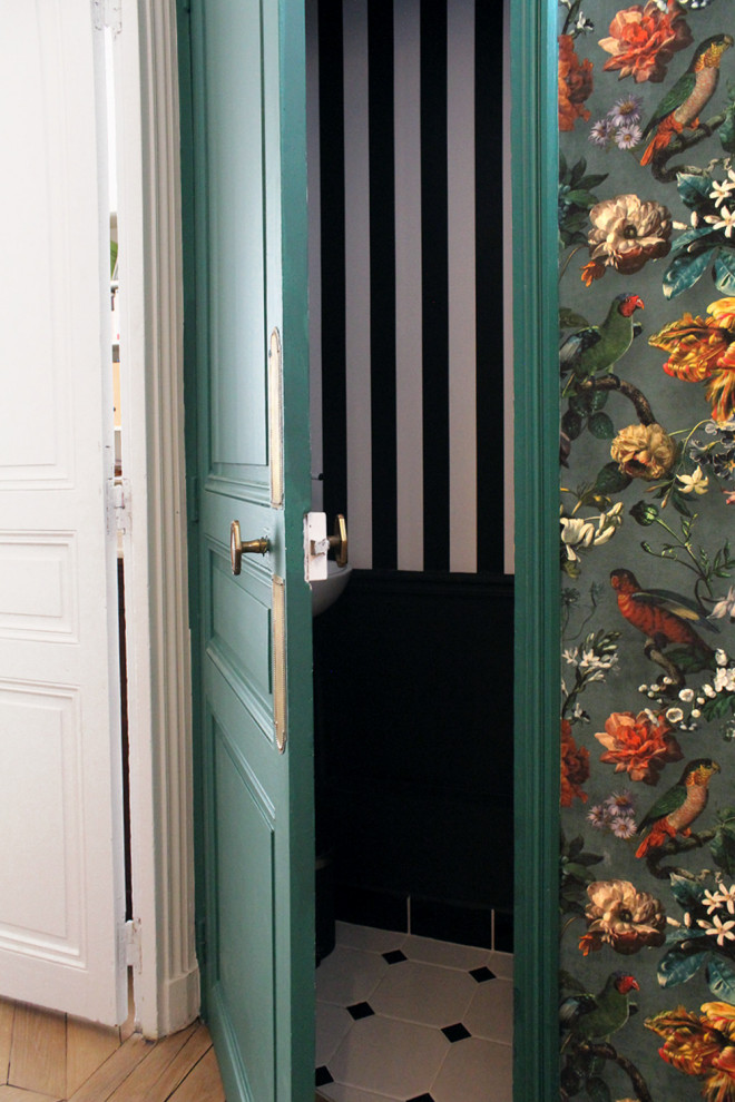 Photo of a small traditional hallway in Paris with multi-coloured walls, light hardwood floors and wallpaper.