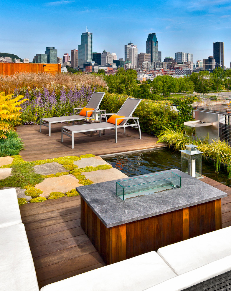 Contemporary rooftop and rooftop deck in Montreal with no cover.