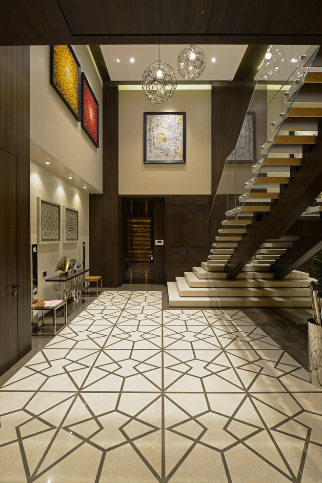 Large contemporary hallway in Mumbai with beige walls and white floor.
