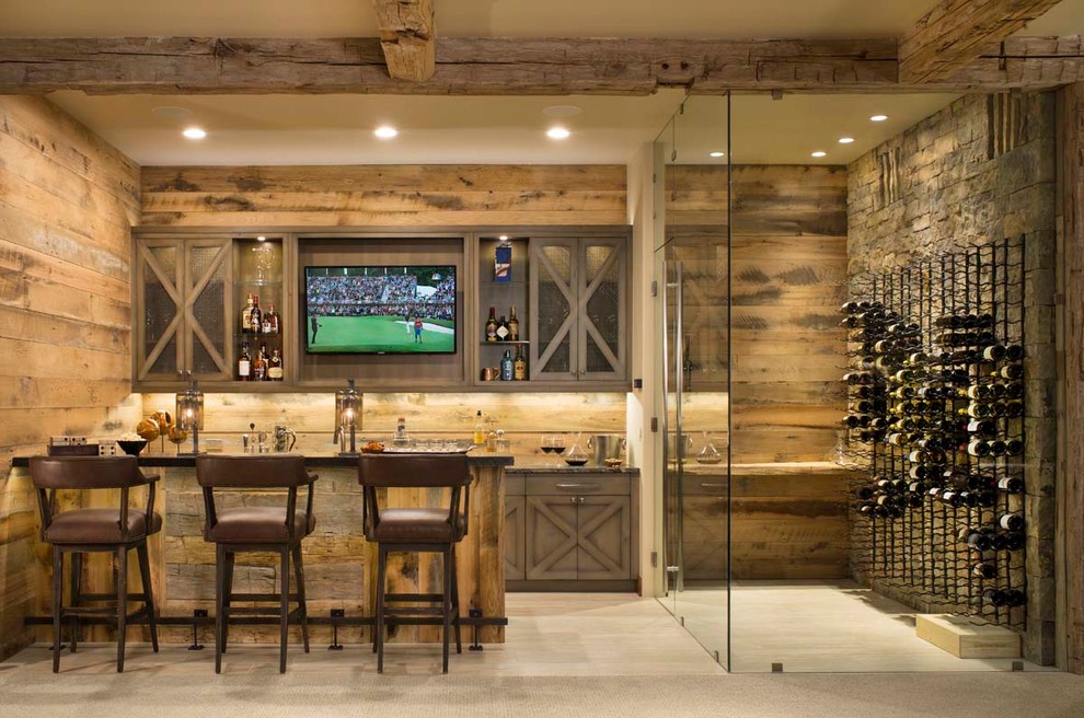 This is an example of a country u-shaped seated home bar in Denver with medium wood cabinets, light hardwood floors, beige floor and grey benchtop.