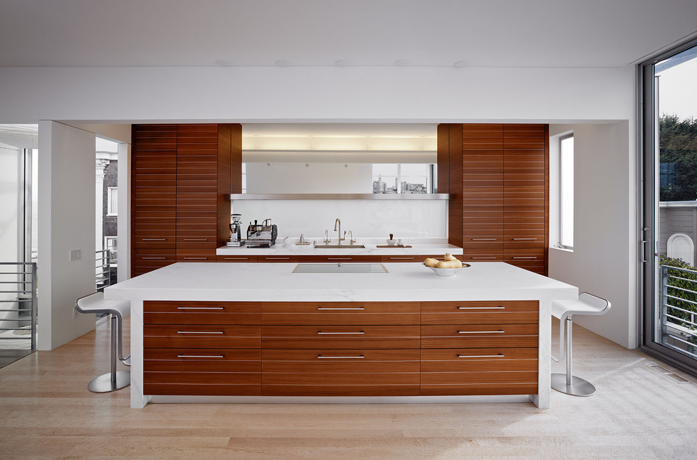 Inspiration for a modern galley kitchen in San Francisco with an undermount sink, flat-panel cabinets, medium wood cabinets and white splashback.