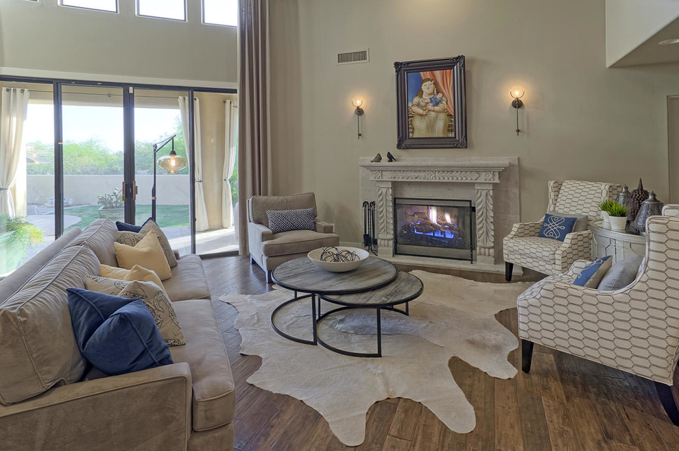 Photo of a large transitional open concept family room in Phoenix with beige walls, dark hardwood floors, a standard fireplace, a stone fireplace surround and no tv.