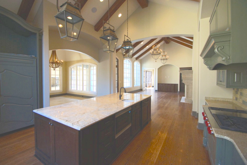 Inspiration for a mid-sized transitional single-wall medium tone wood floor open concept kitchen remodel in Nashville with an undermount sink, recessed-panel cabinets, medium tone wood cabinets, granite countertops, multicolored backsplash, ceramic backsplash, stainless steel appliances and an island