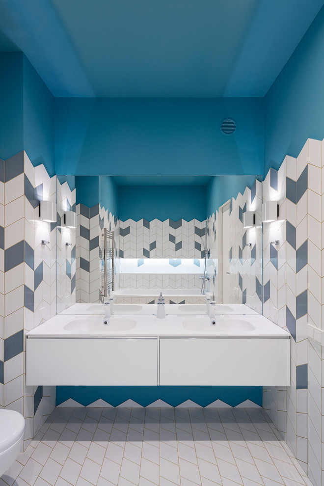 Design ideas for a contemporary kids bathroom in Moscow with flat-panel cabinets, white cabinets, blue tile, white tile, blue walls, white floor and an integrated sink.