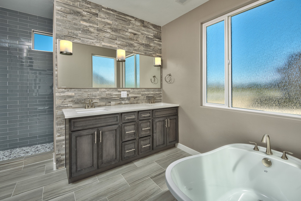 Design ideas for a large contemporary master bathroom in Other with recessed-panel cabinets, medium wood cabinets, a freestanding tub, an alcove shower, a two-piece toilet, gray tile, ceramic tile, grey walls, ceramic floors, an undermount sink, laminate benchtops, grey floor, an open shower and white benchtops.