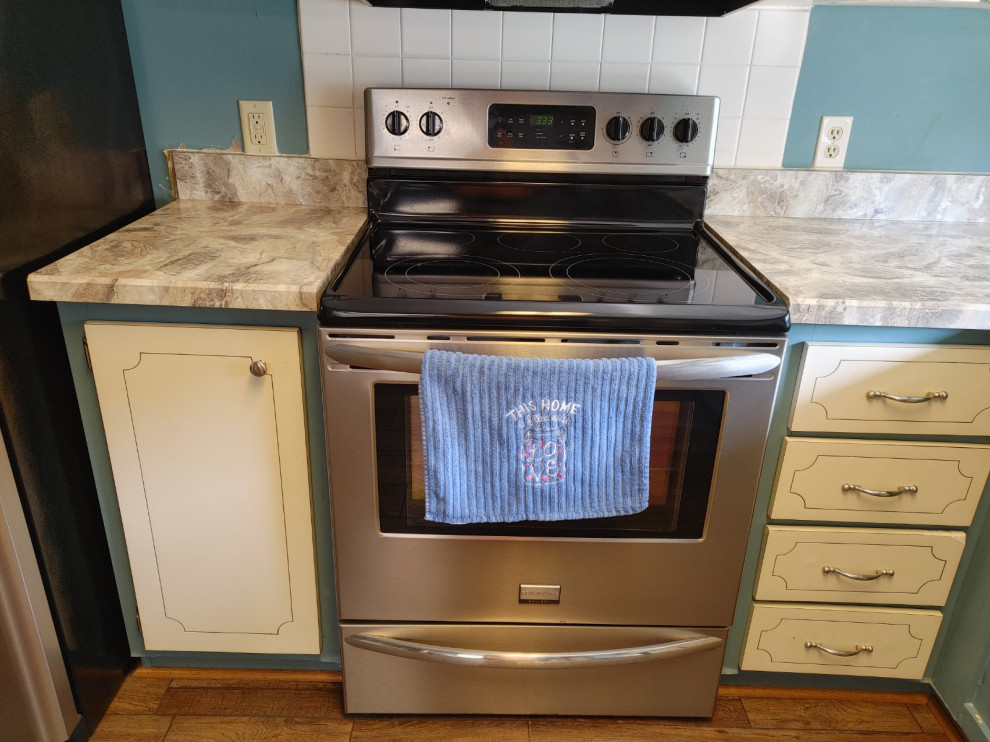 Inspiration for a mid-sized kitchen remodel with white cabinets, laminate countertops, an island and beige countertops