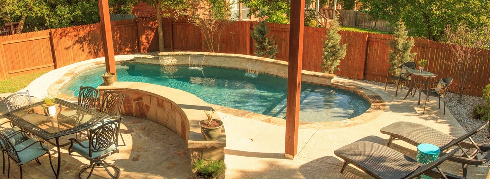 This is an example of a mid-sized traditional backyard custom-shaped pool in Austin with a water feature and concrete slab.