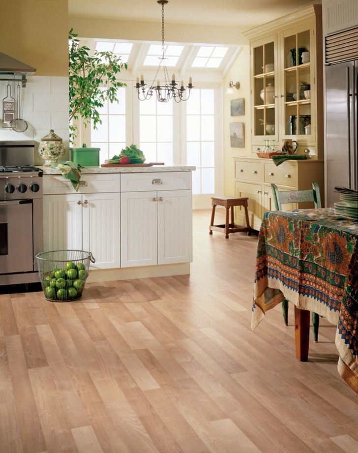 Large transitional l-shaped light wood floor and brown floor eat-in kitchen photo with white cabinets, white backsplash, subway tile backsplash, stainless steel appliances, no island, marble countertops, a farmhouse sink and recessed-panel cabinets