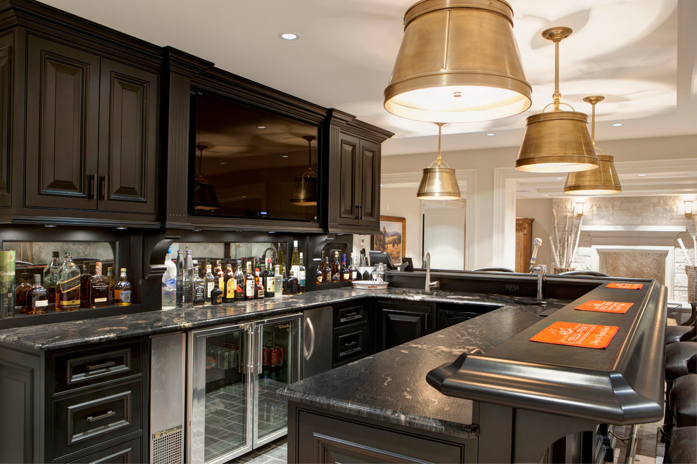 Mid-sized traditional galley seated home bar in Toronto with an undermount sink, raised-panel cabinets, black cabinets, granite benchtops and light hardwood floors.