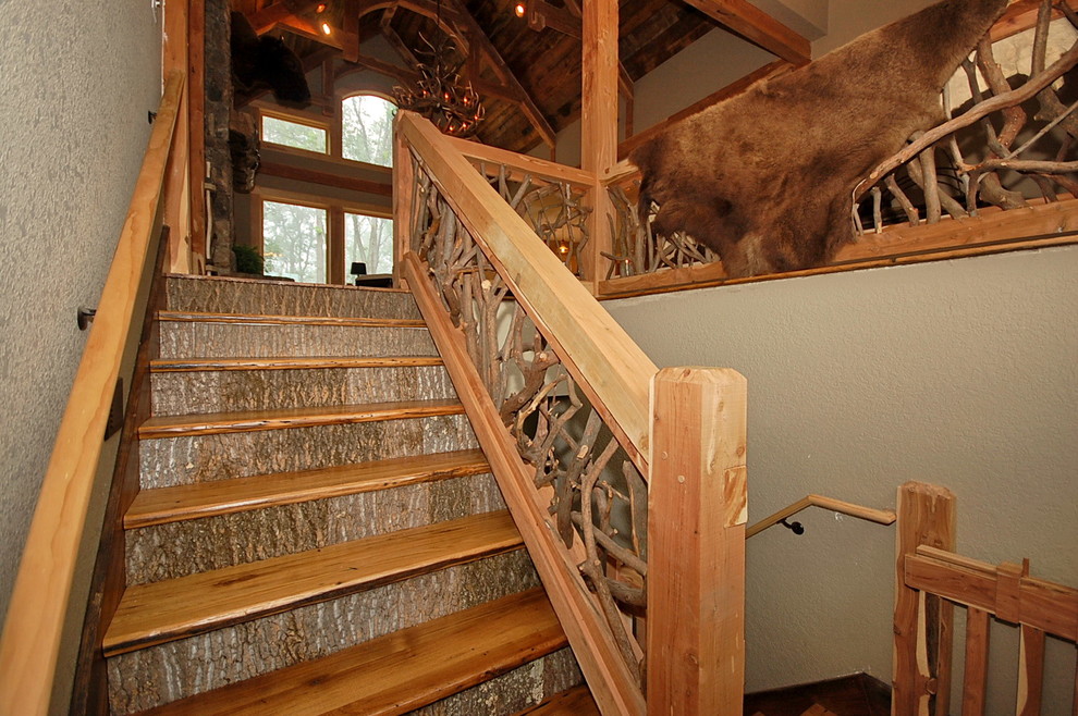 Large mountain style wooden u-shaped wood railing staircase photo with wooden risers