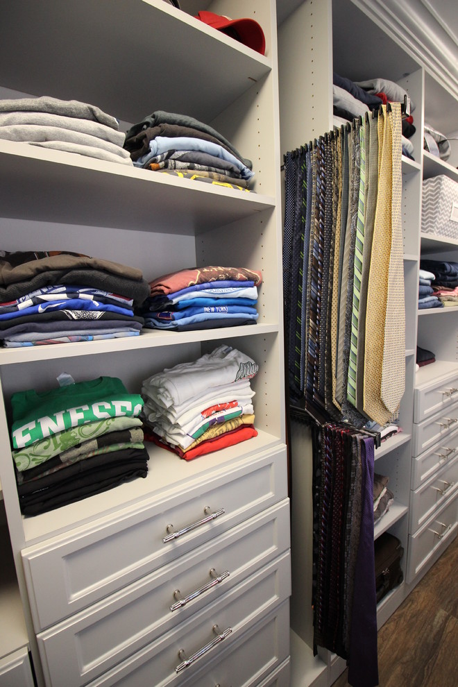 Example of a large transitional gender-neutral linoleum floor walk-in closet design with recessed-panel cabinets and gray cabinets