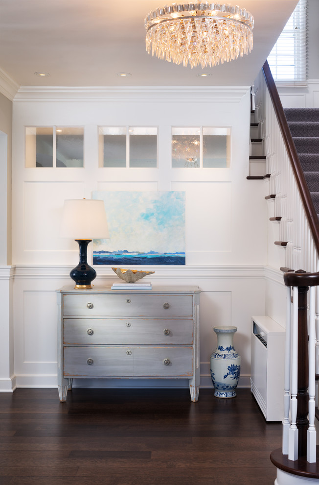 Design ideas for a traditional foyer in Minneapolis with white walls and dark hardwood floors.