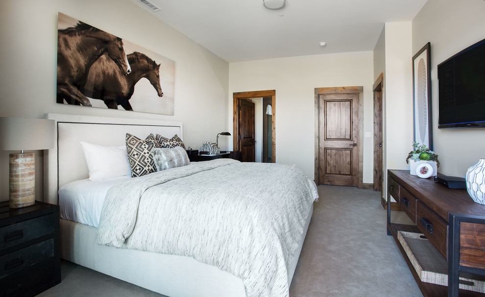 Example of a mountain style guest carpeted bedroom design in Salt Lake City with beige walls