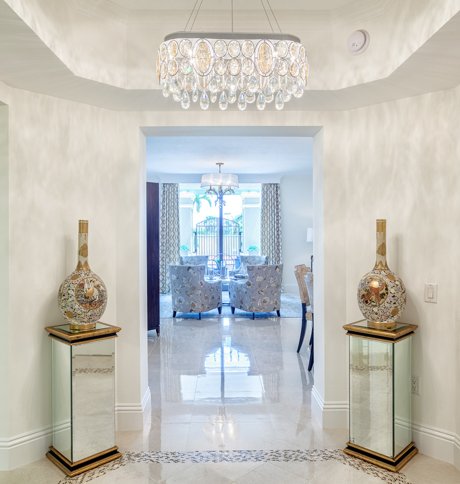 Example of a large transitional marble floor foyer design in Miami with white walls and a white front door
