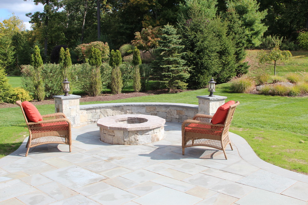Design ideas for a large traditional backyard patio in New York with a fire feature, tile and no cover.