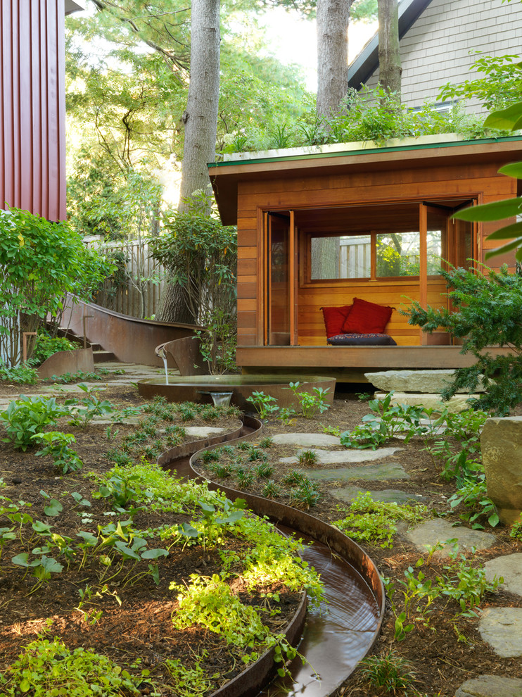 Photo of a contemporary backyard full sun garden in Boston with a water feature and natural stone pavers.