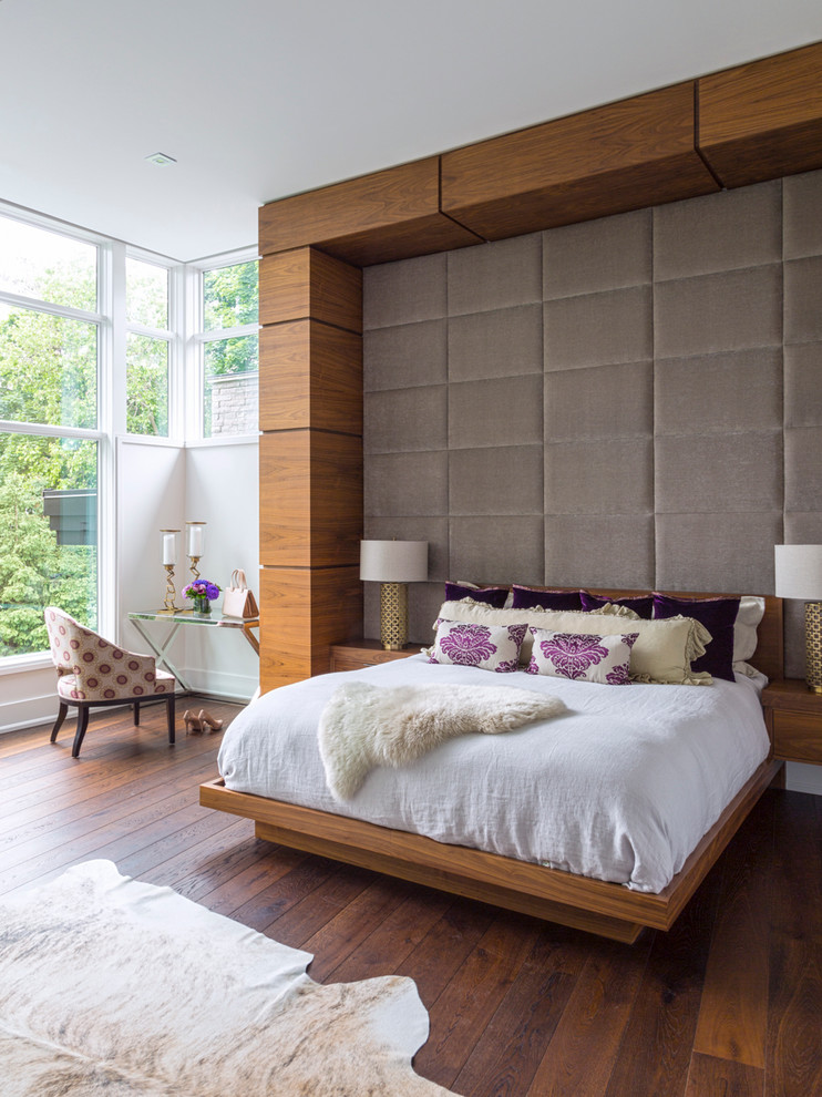 This is an example of a large contemporary master bedroom in Toronto with white walls and dark hardwood floors.