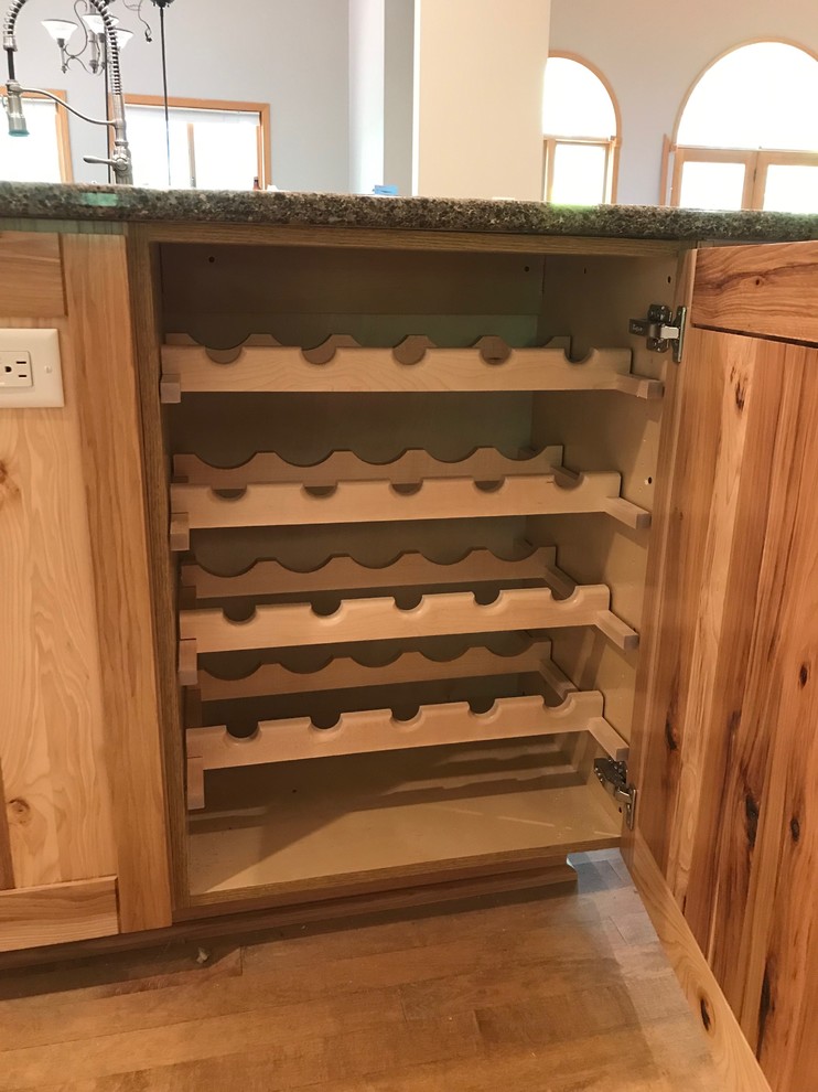 Example of a mid-sized mountain style galley eat-in kitchen design with an island