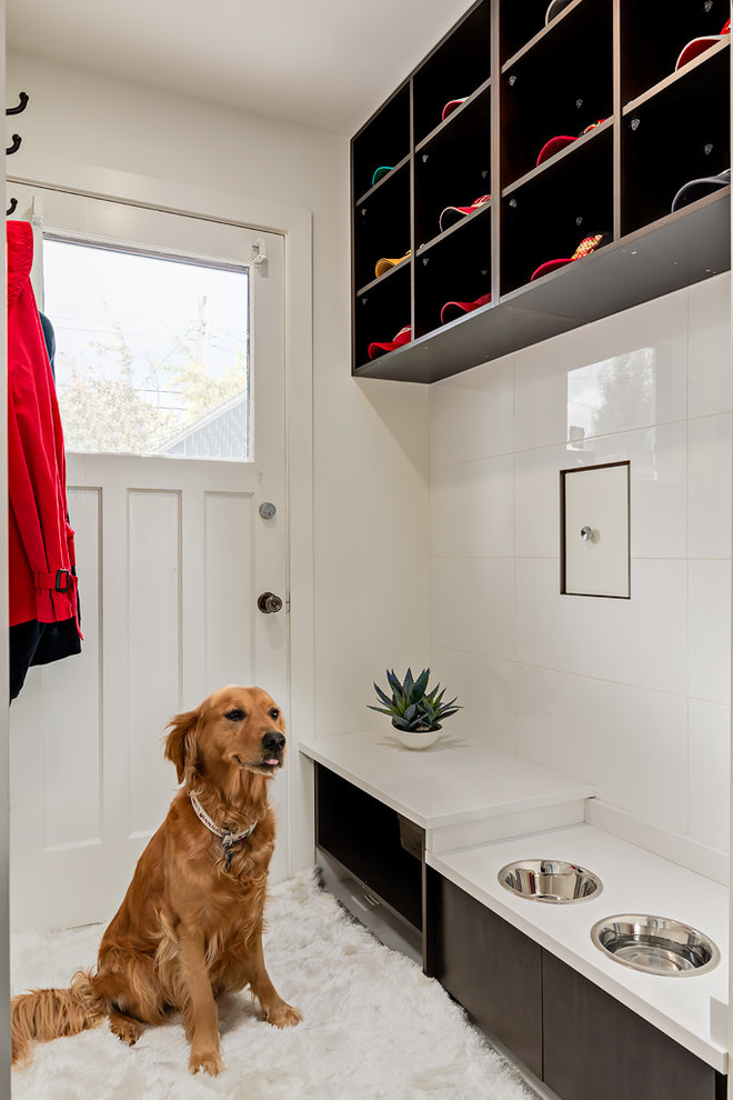 Inspiration for a mid-sized contemporary mudroom in Calgary with white walls and carpet.