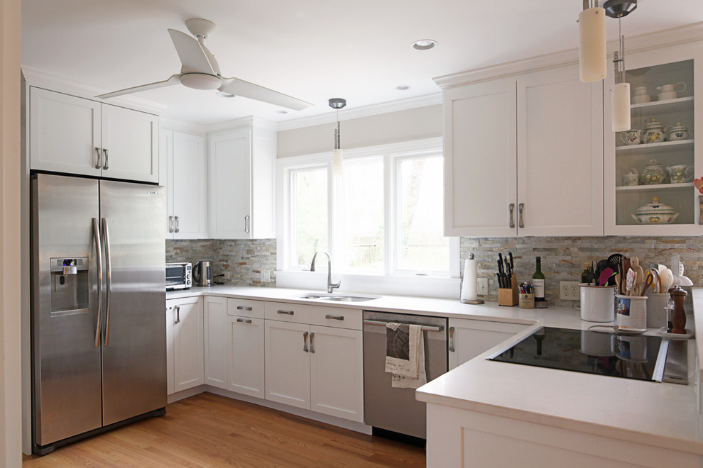 Eat-in kitchen - mid-sized transitional u-shaped eat-in kitchen idea with flat-panel cabinets, white cabinets and a peninsula