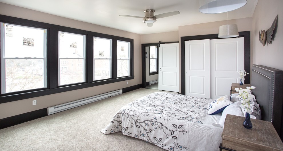 Inspiration for a large transitional guest carpeted and gray floor bedroom remodel with gray walls