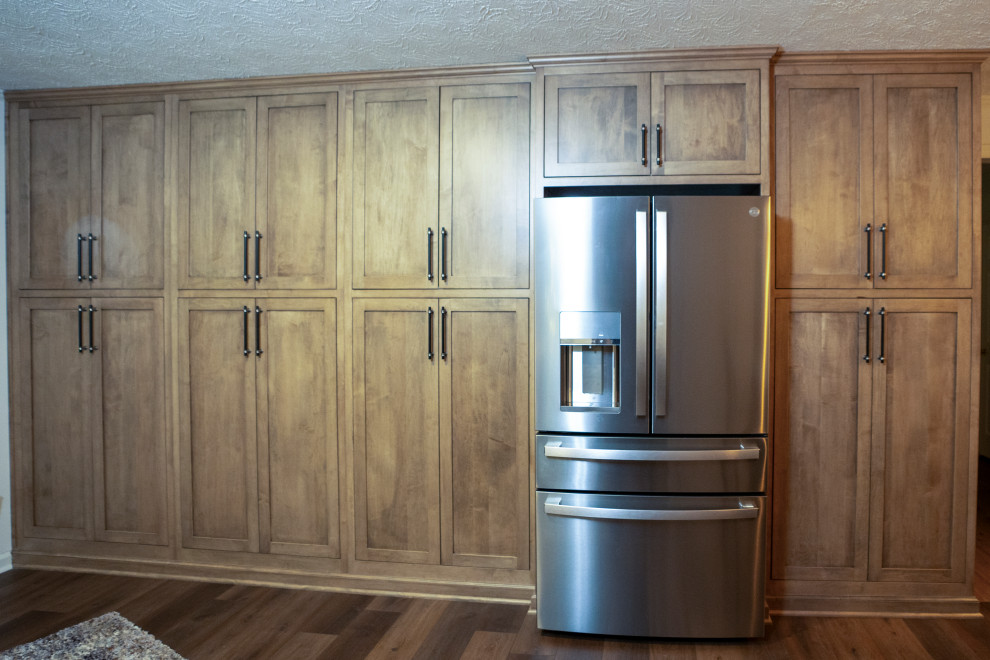 Example of a large transitional medium tone wood floor and brown floor eat-in kitchen design with shaker cabinets, medium tone wood cabinets and stainless steel appliances