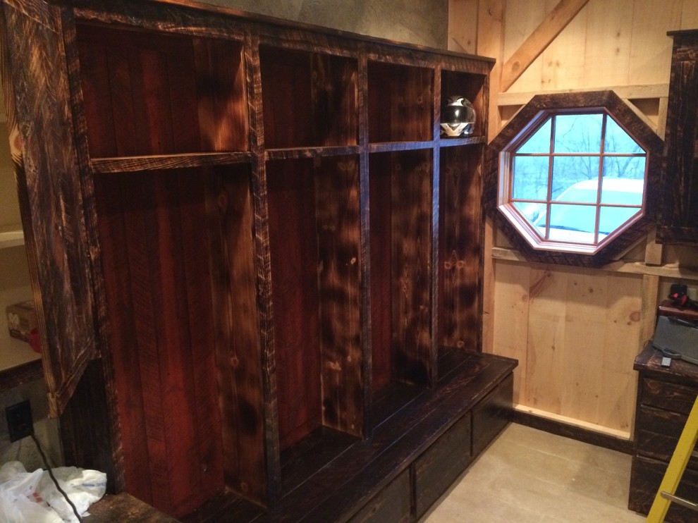 Example of a small mountain style light wood floor and beige floor mudroom design with beige walls