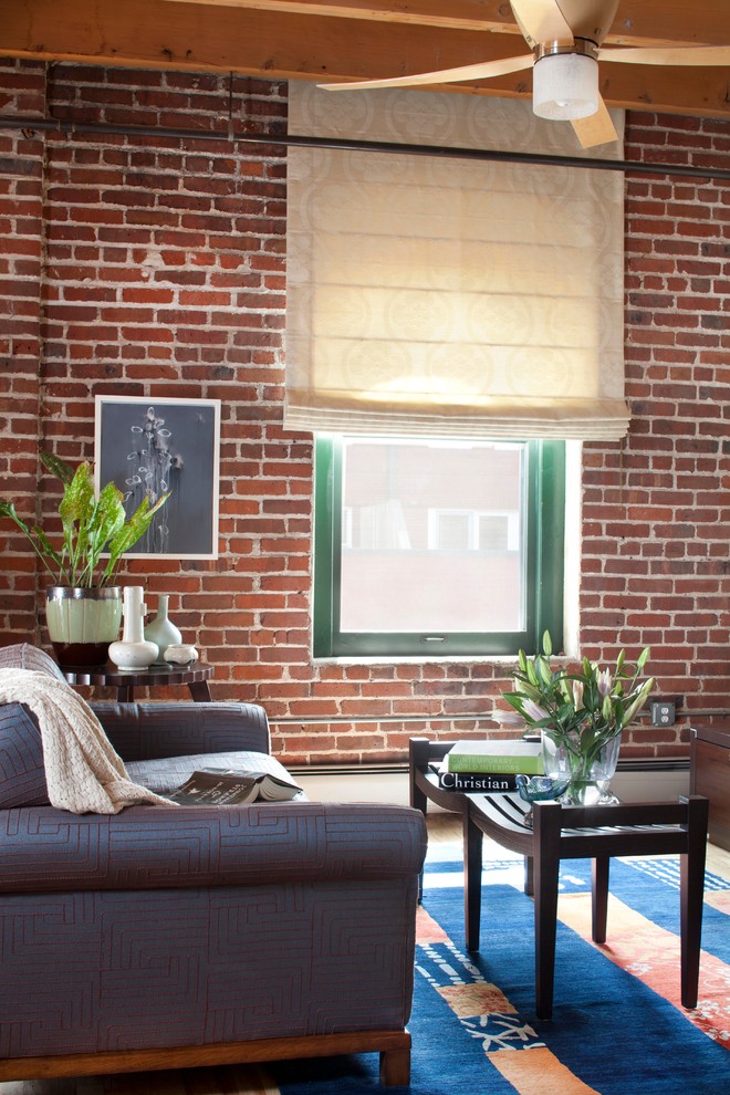 Inspiration for a mid-sized contemporary loft-style living room in Denver with beige walls and light hardwood floors.