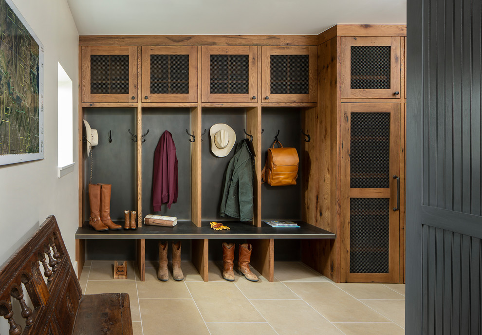 Photo of a country mudroom in Denver with white walls and beige floor.